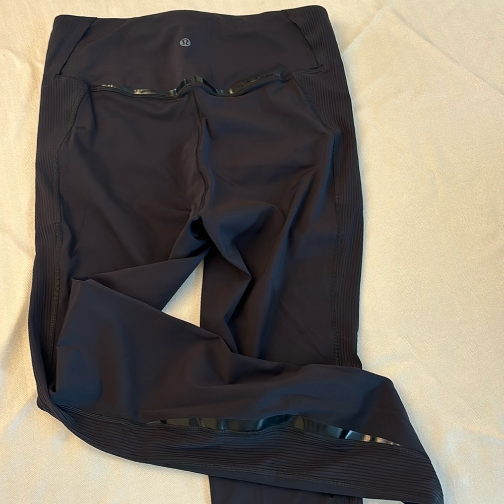 Lululemon size 8 with thin faux leather trim on waste/thighs. Barely worn